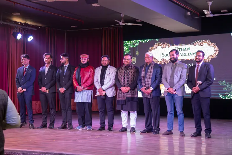 Guests and organisers standing in a row on stage