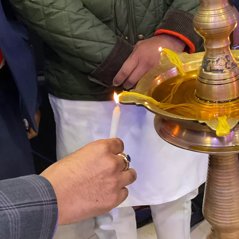Close-up of a candle lighting the brass lamp