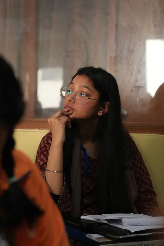 A delegate rests a chin on one hand, deep in thought