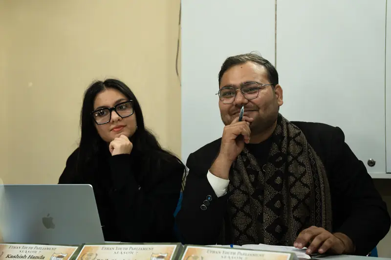Two members of the Executive Board listening from the dais